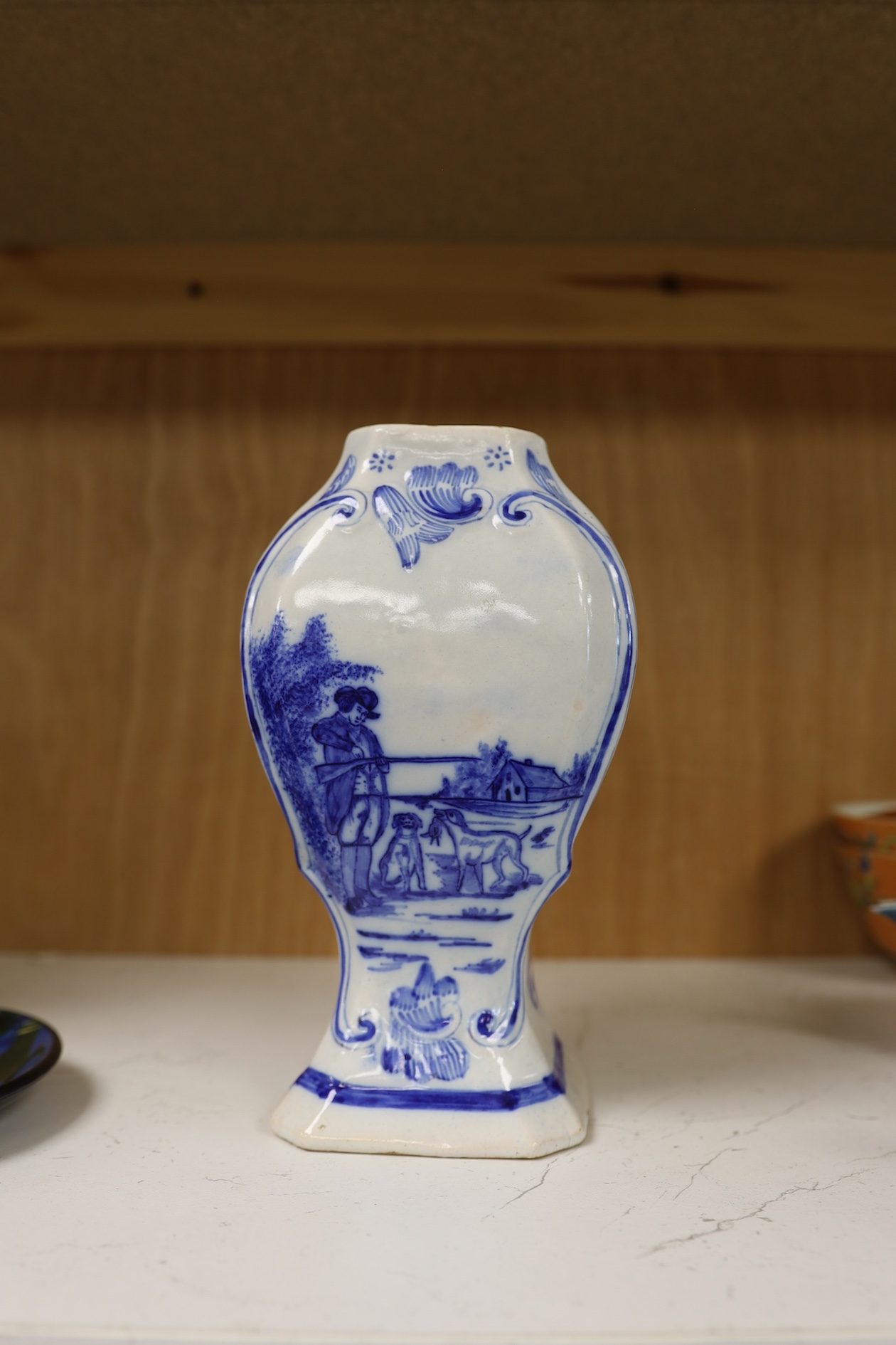 A 19th century Delft blue and white vase and a Watcombe Torquay pottery chamberstick, 19.5cm. Condition - both fair